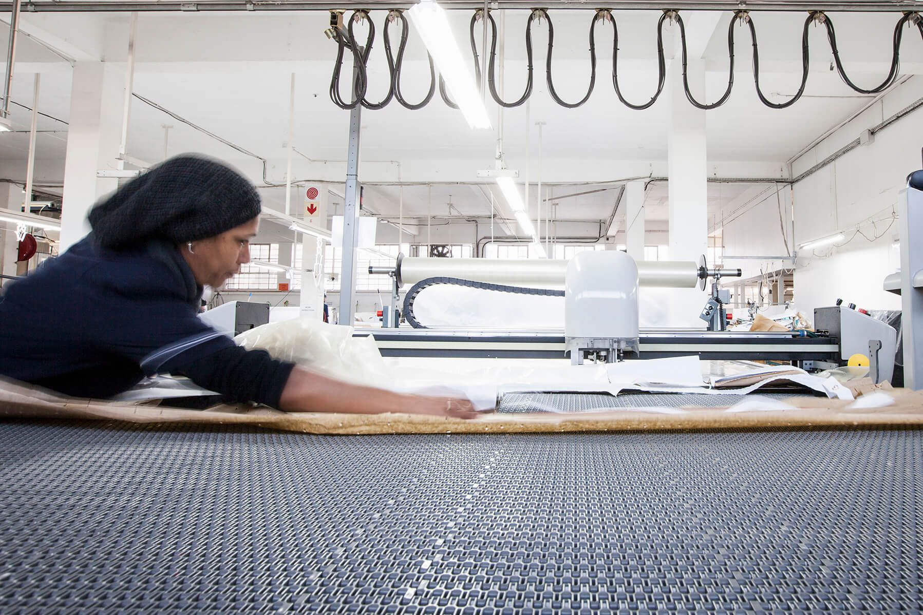 A woman is working on a machine in a factory