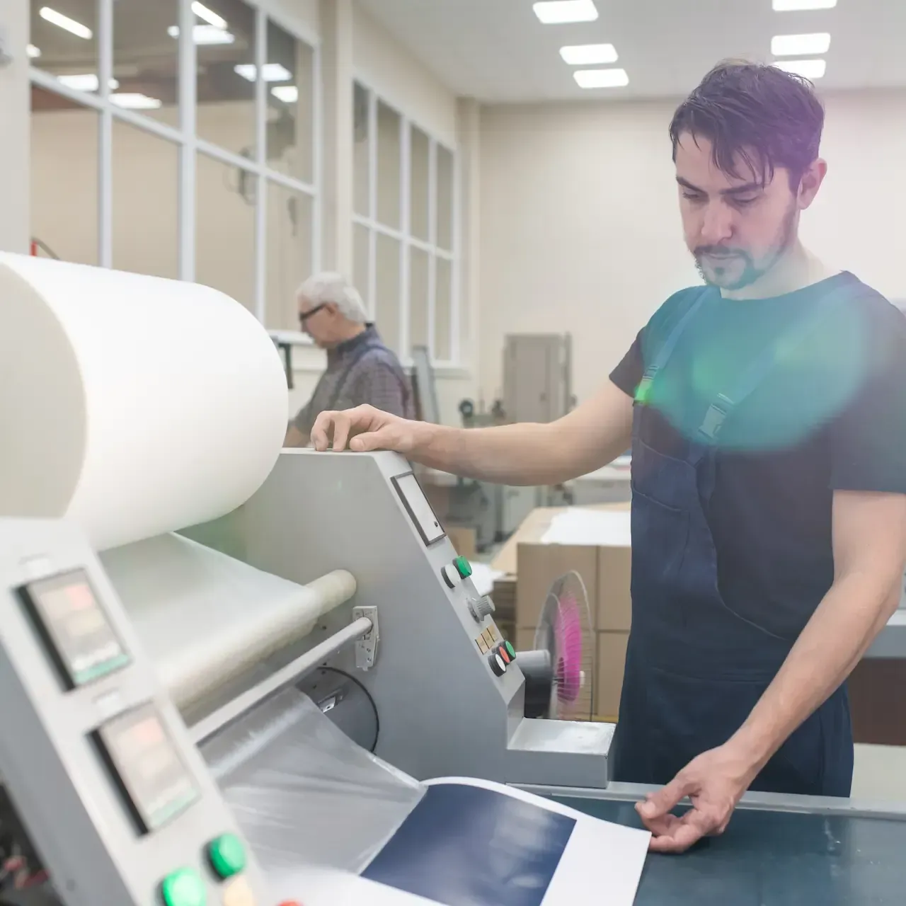 Professional large format lamination and textured lamination poster production at industrial laminating facility