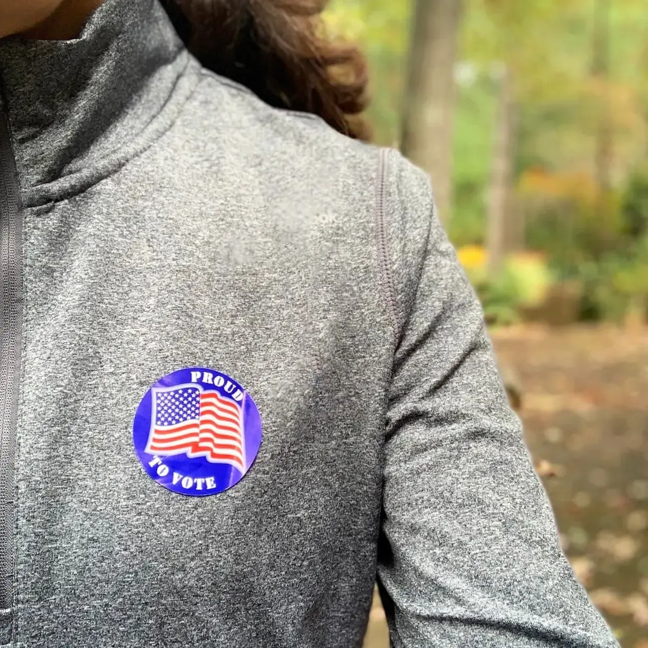 Person wearing a gray sweatshirt with a 