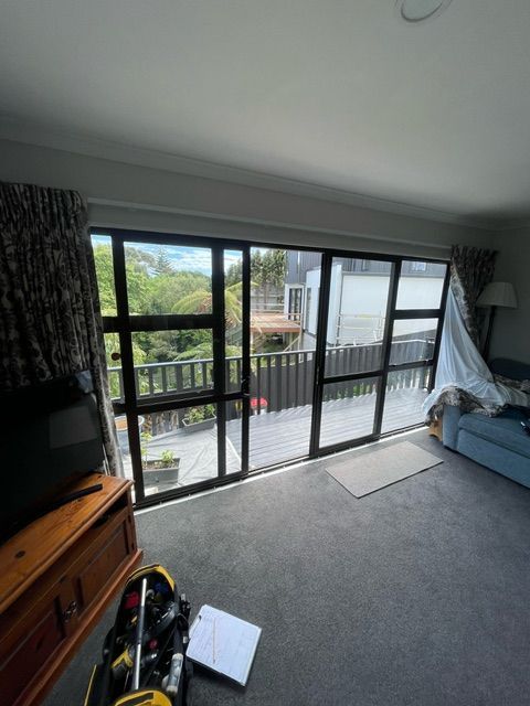 A Living Room with a Huge Window and a Couch — Lower Hutt, NZ — Complete Aluminium Maintenance Ltd