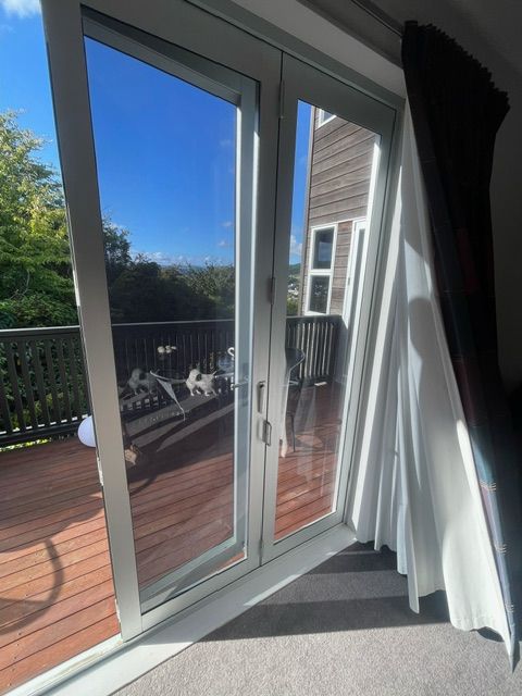 A Room with a Sliding Glass Door Leading to a Deck — Lower Hutt, NZ — Complete Aluminium Maintenance Ltd