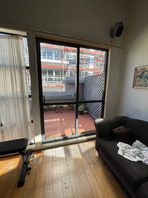A Living Room with a Couch and a Sliding Glass Door — Lower Hutt, NZ — Complete Aluminium Maintenance Ltd
