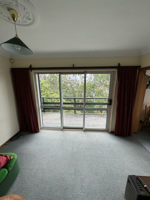 A Living Room with a Sliding Glass Door and a Balcony — Lower Hutt, NZ — Complete Aluminium Maintenance Ltd