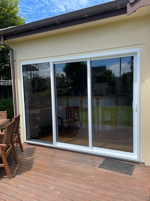 A House with a Sliding Glass Door and a Wooden Deck — Lower Hutt, NZ — Complete Aluminium Maintenance Ltd