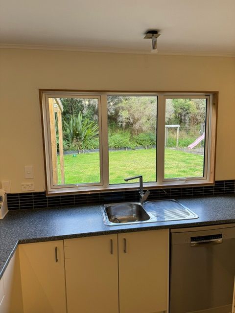 A Kitchen with a Sink, Dishwasher, and Large Window — Lower Hutt, NZ — Complete Aluminium Maintenance Ltd