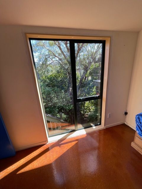 A Room with a Sliding Glass Door and a View of Trees — Lower Hutt, NZ — Complete Aluminium Maintenance Ltd