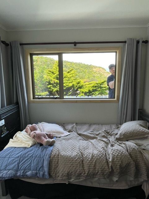 Bed in Front of a Window — Lower Hutt, NZ — Complete Aluminium Maintenance Ltd