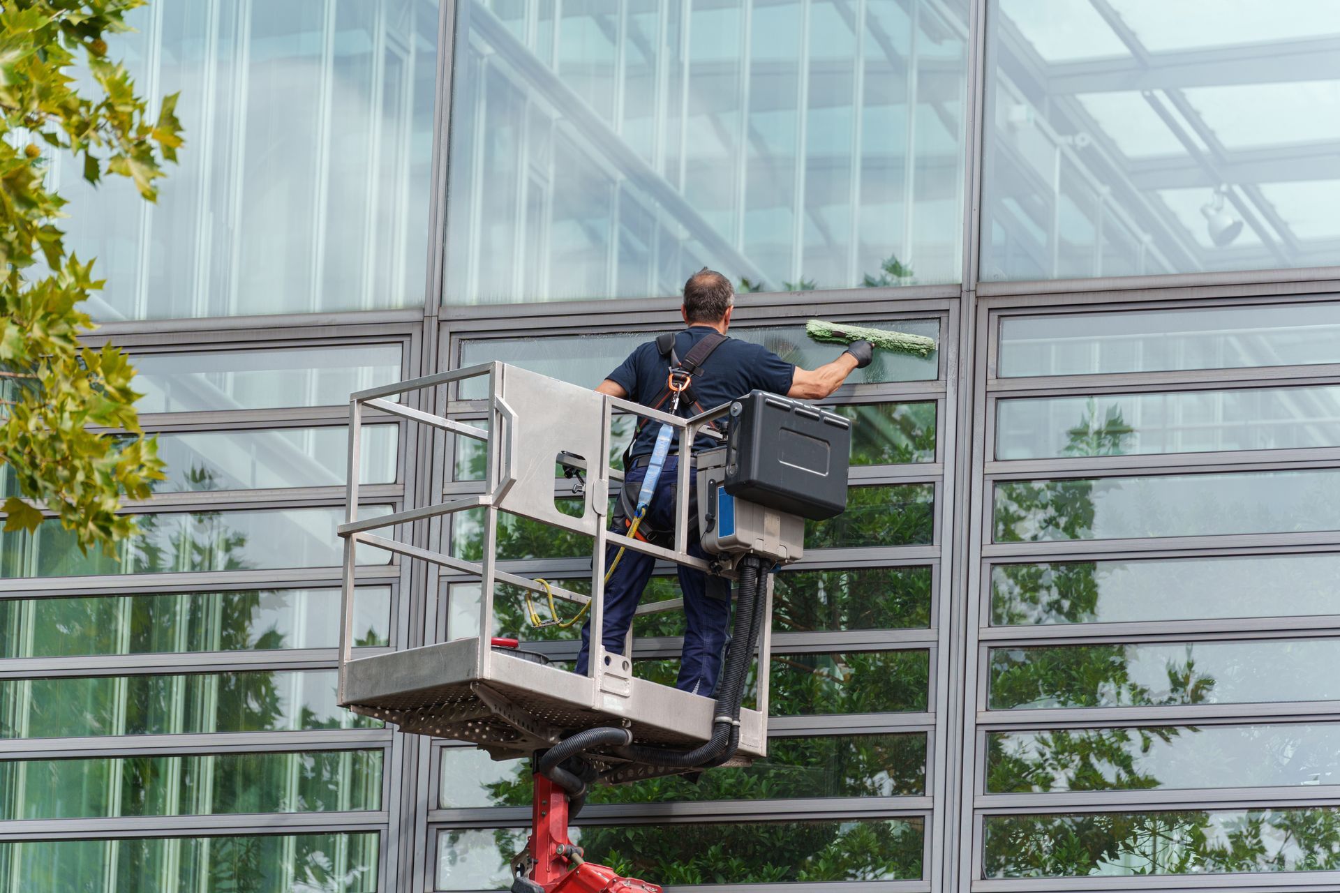 man cleaning office building windows