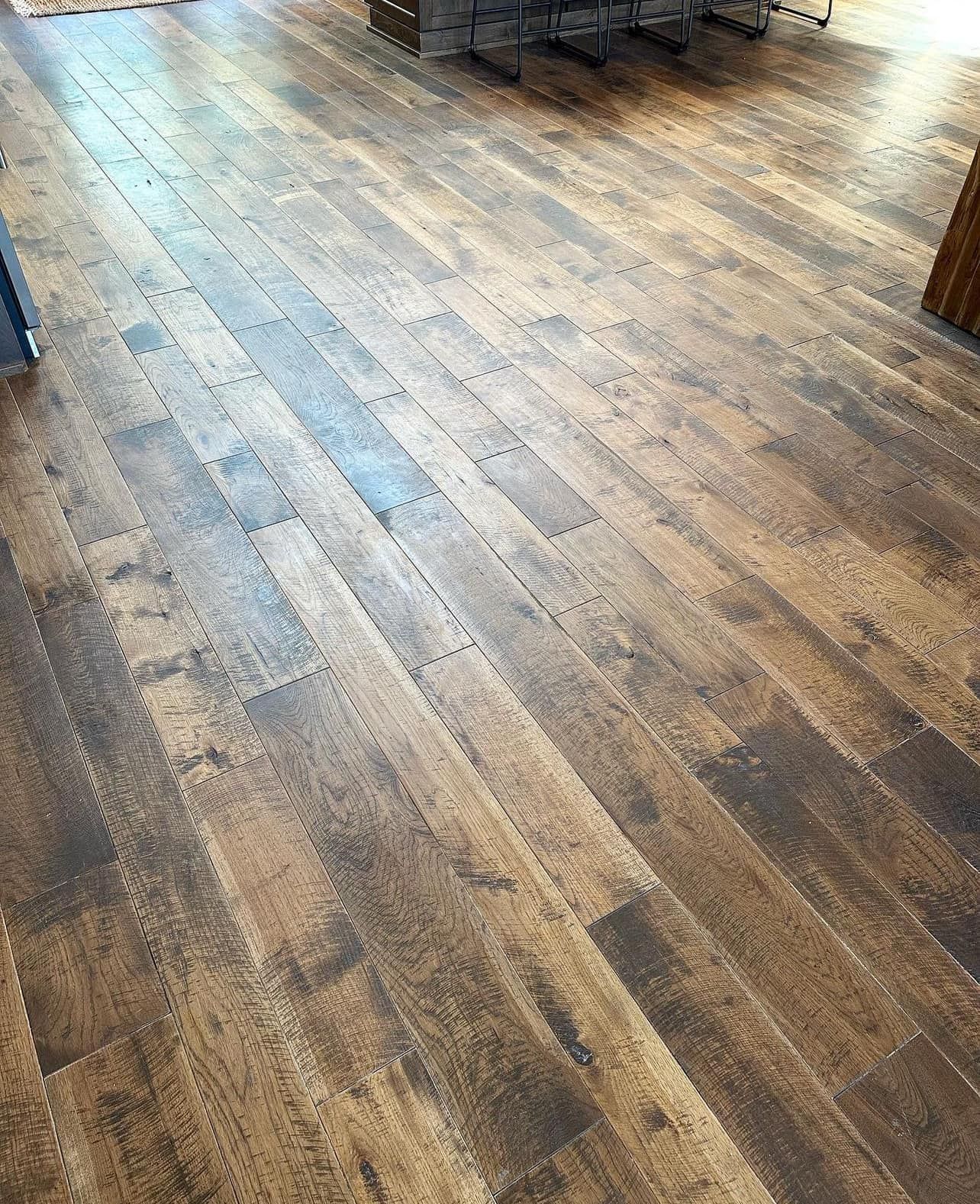 A close up of a wooden floor in a room.