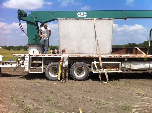 A man is standing next to a gmc truck
