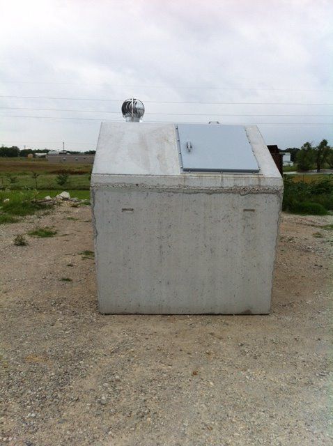 A large concrete box with a metal door on top of it
