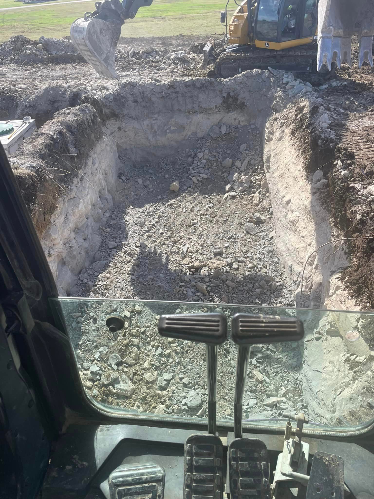 A bulldozer is digging a hole in the ground.