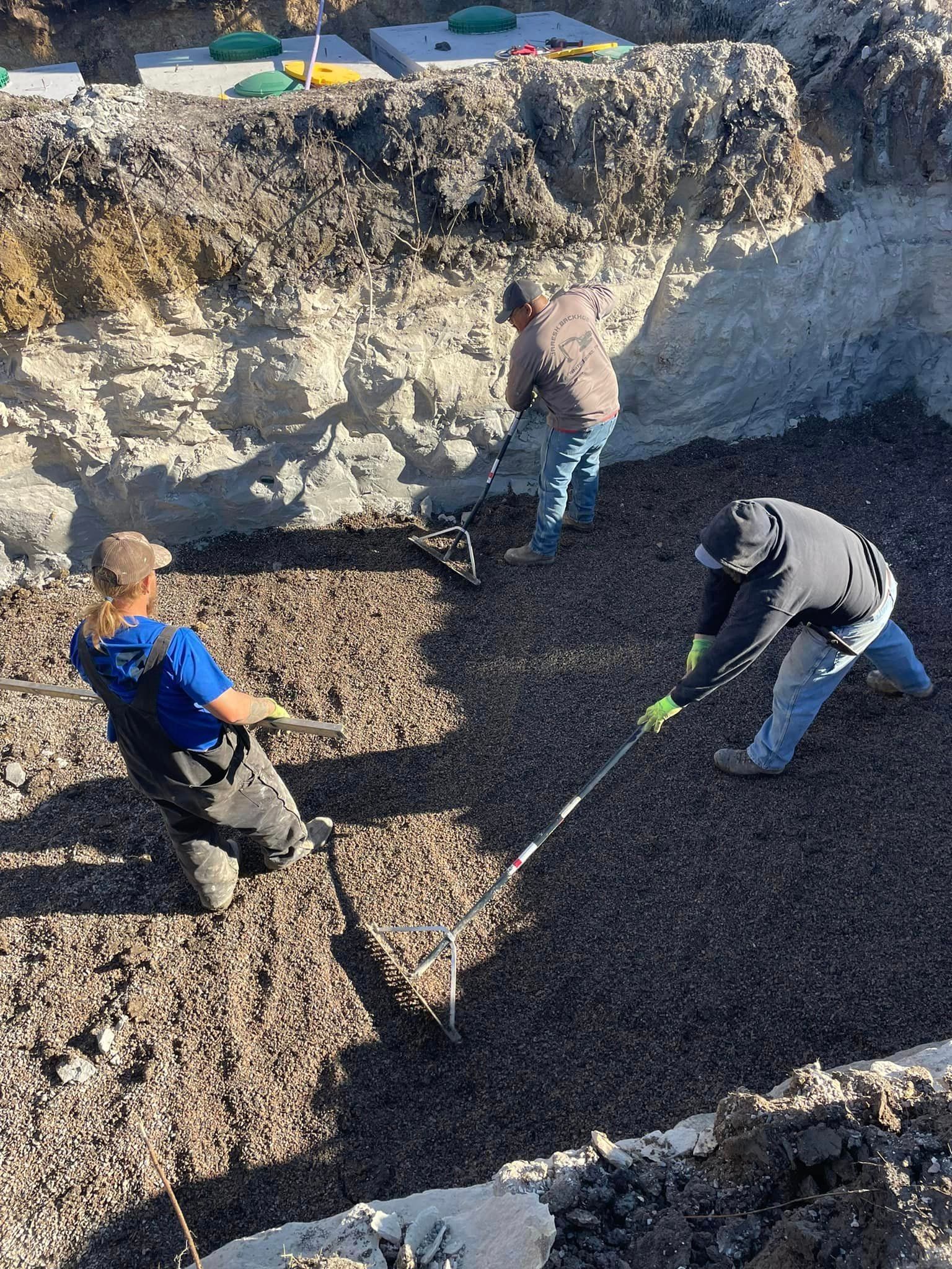 Two men are digging in the dirt with shovels.