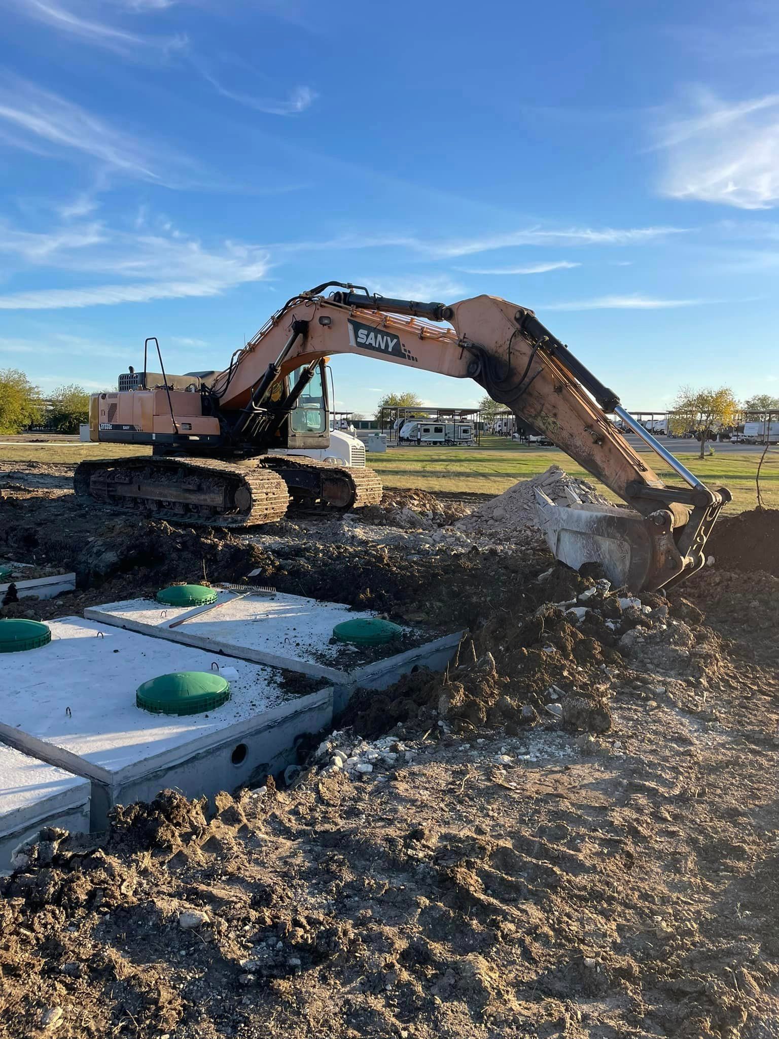 A large excavator is digging a hole in the dirt.