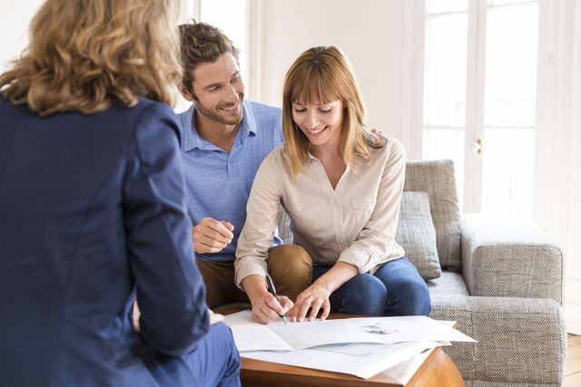 A man and a woman are sitting at a table with a woman.