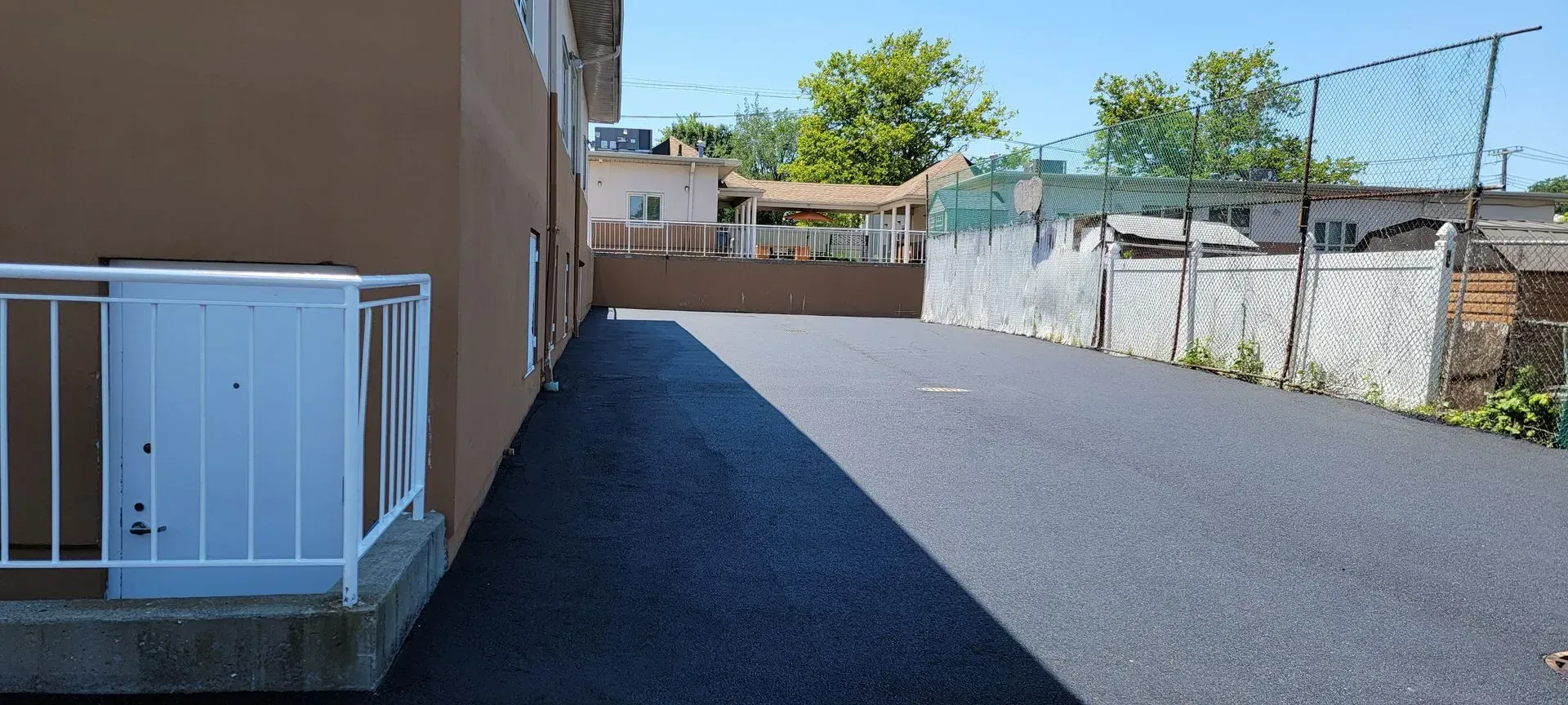 A brown building with a white railing on the side of it.