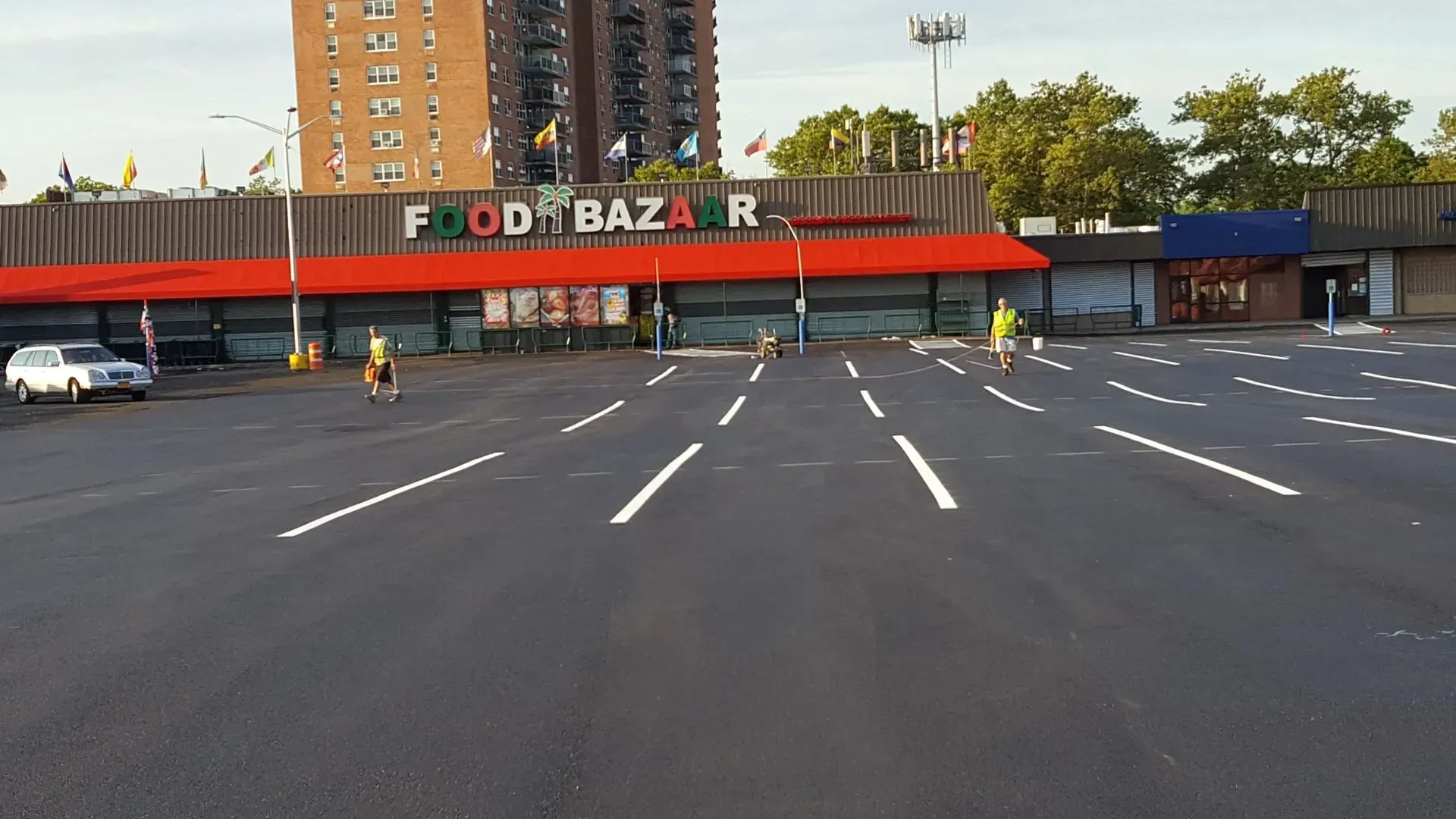 An empty parking lot in front of a food bazaar.