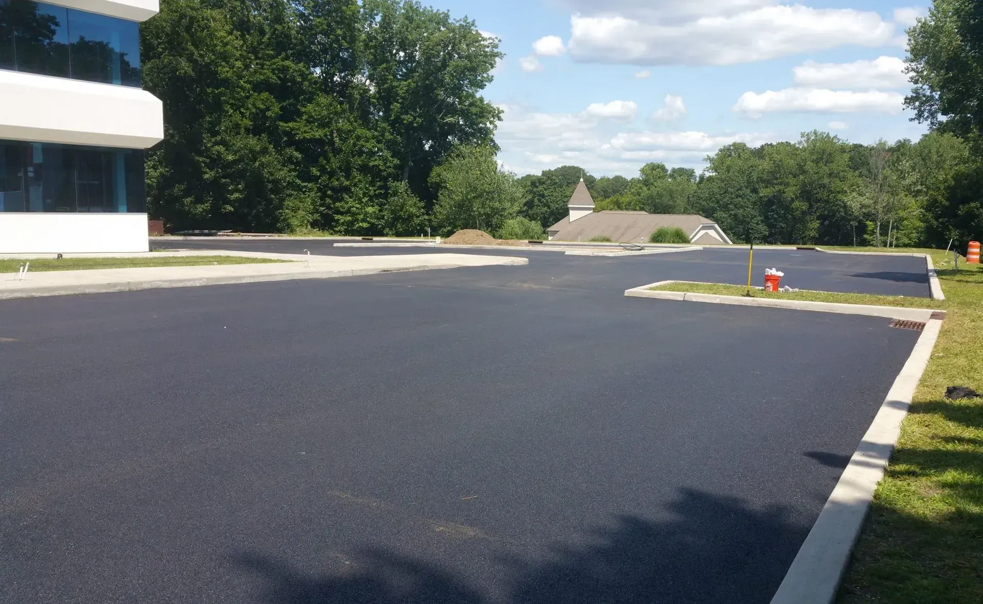 A large parking lot with a building in the background.