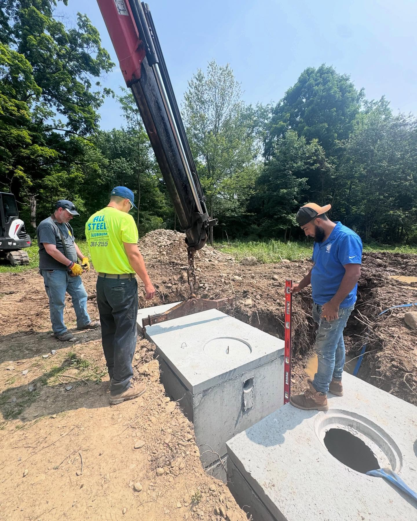 Modern bathroom with white tub, light wood vanity, and two illuminated mirrors.