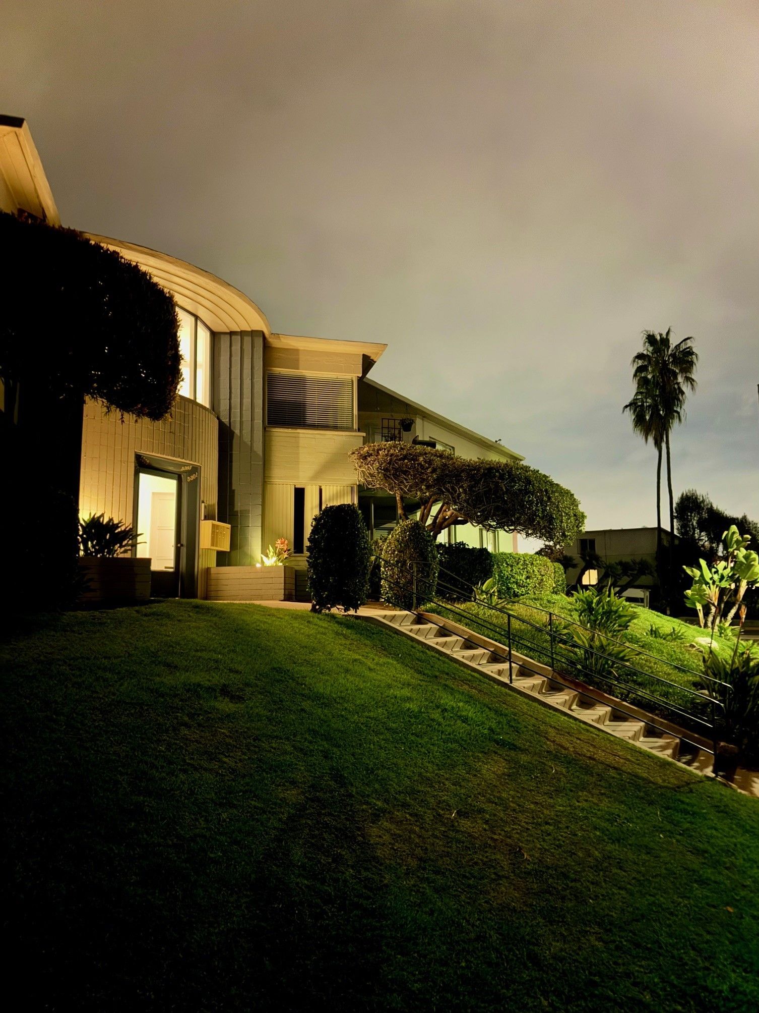 A large house with a lush green lawn in front of it