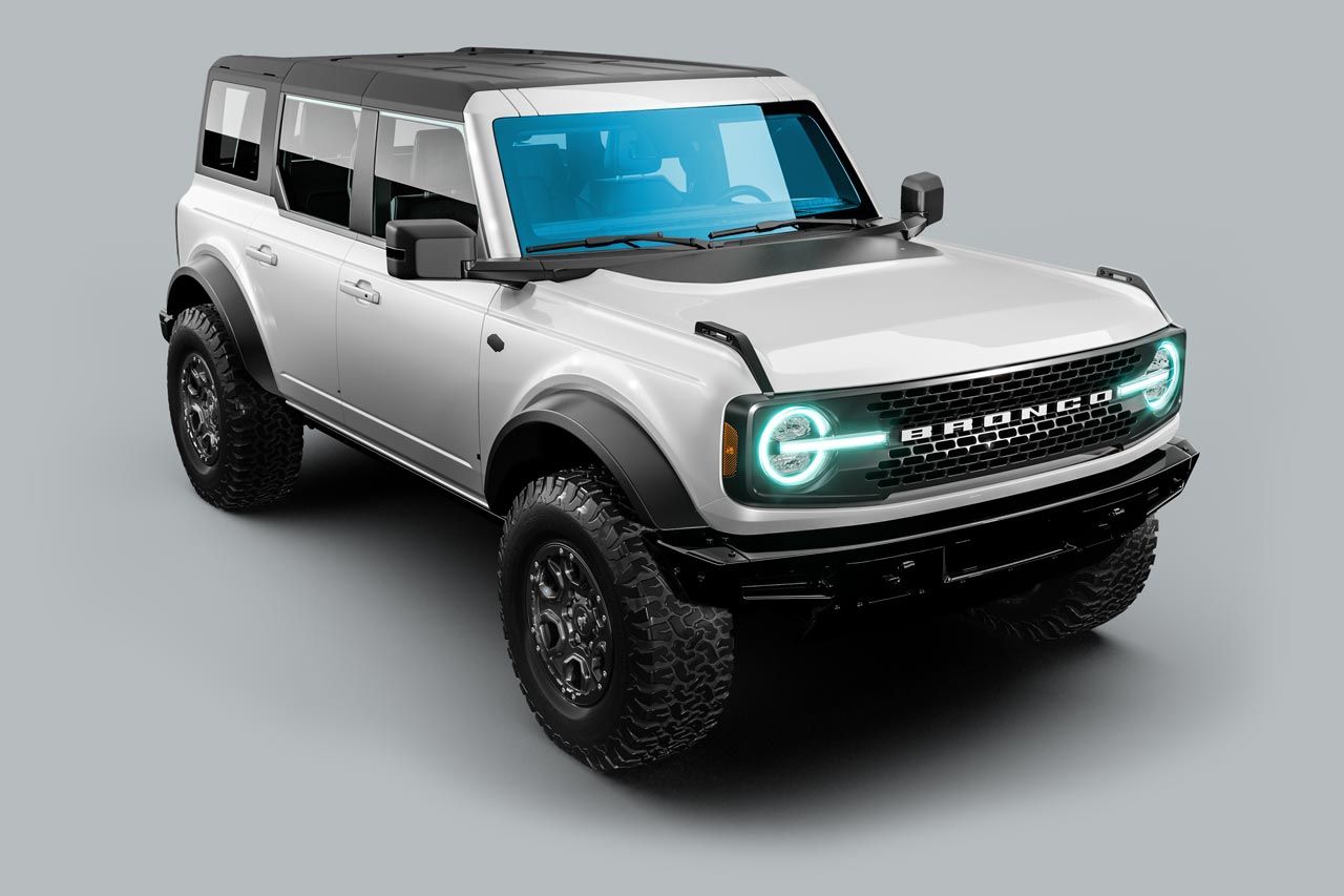 White Ford Bronco SUV on gray background. Black accents, off-road tires, and circular headlights.