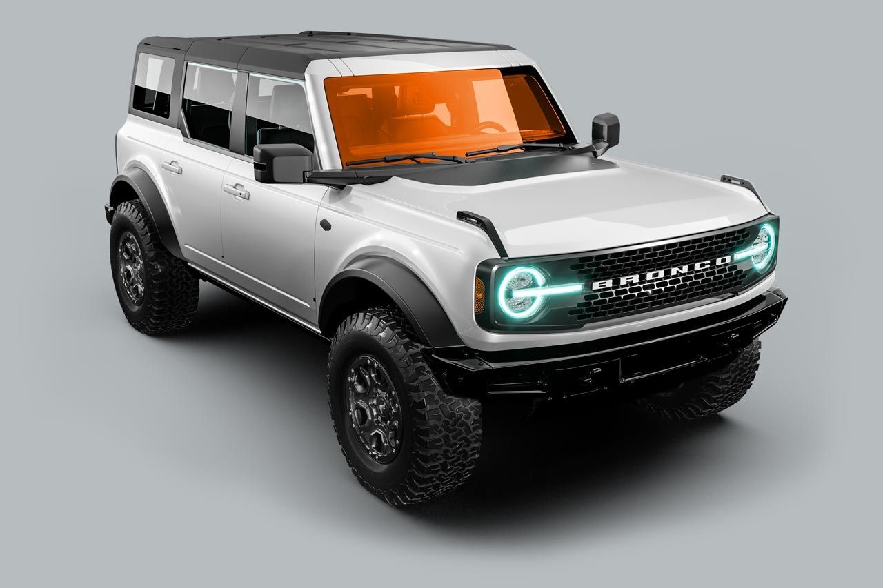 White Ford Bronco SUV with black accents and orange tinted windows.