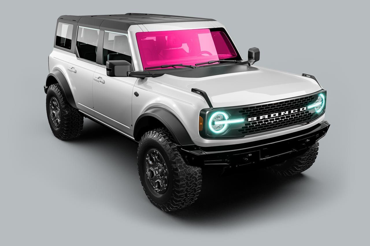 White Ford Bronco SUV with pink tinted windows on a gray background.