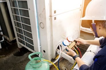Technician Checking Air Conditioner - Salisbury, MD - Eastern Shore Heating & Air Inc