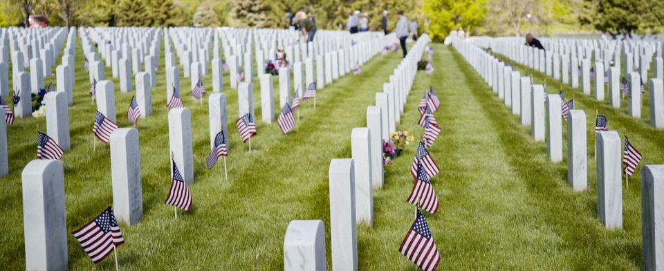 military funeral graves with small american flags