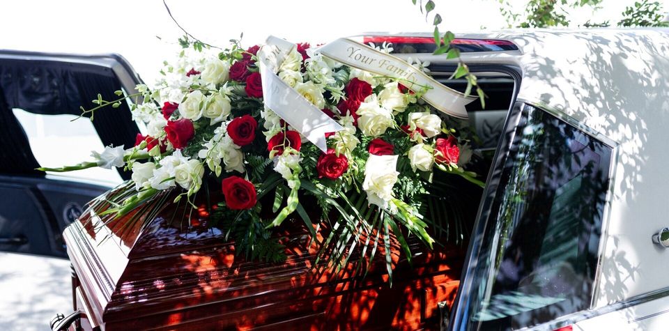 planning a burial service burial casket flowers in car