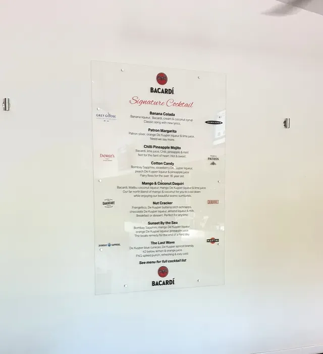 A bacardi menu is hanging on a white wall- Sponsorship Signage in Port Douglas, QLD