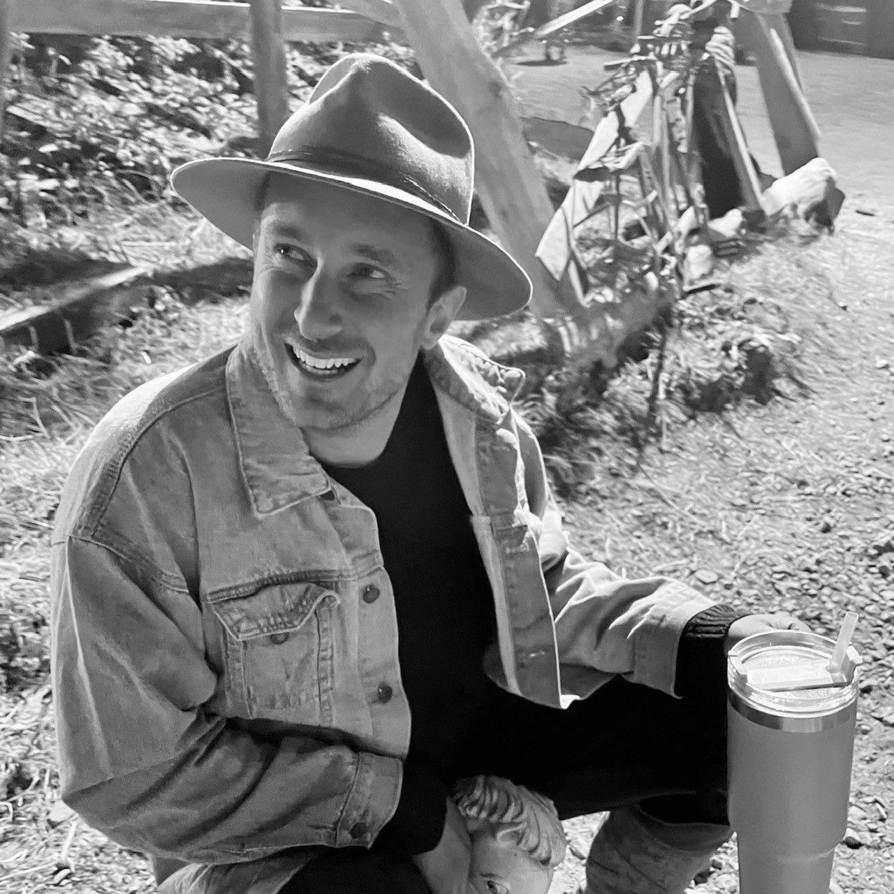 A Black And White Photo Of A Man Wearing A Hat And A Denim Jacket — Quality Printing In Port Douglas, QLD