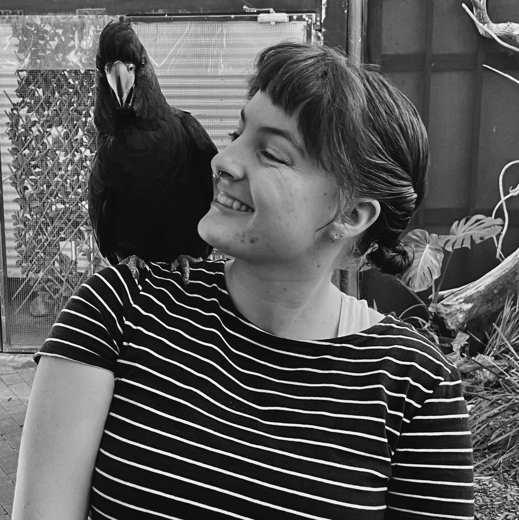 A black and white photo of a woman with a bird on her shoulder — Quality Printing In Port Douglas, QLD