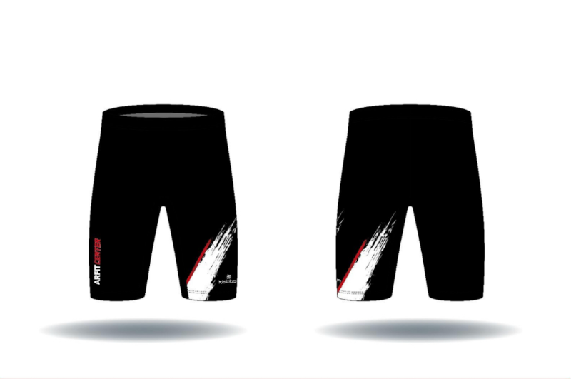 Un par de pantalones cortos negros con una raya roja y blanca en el costado.