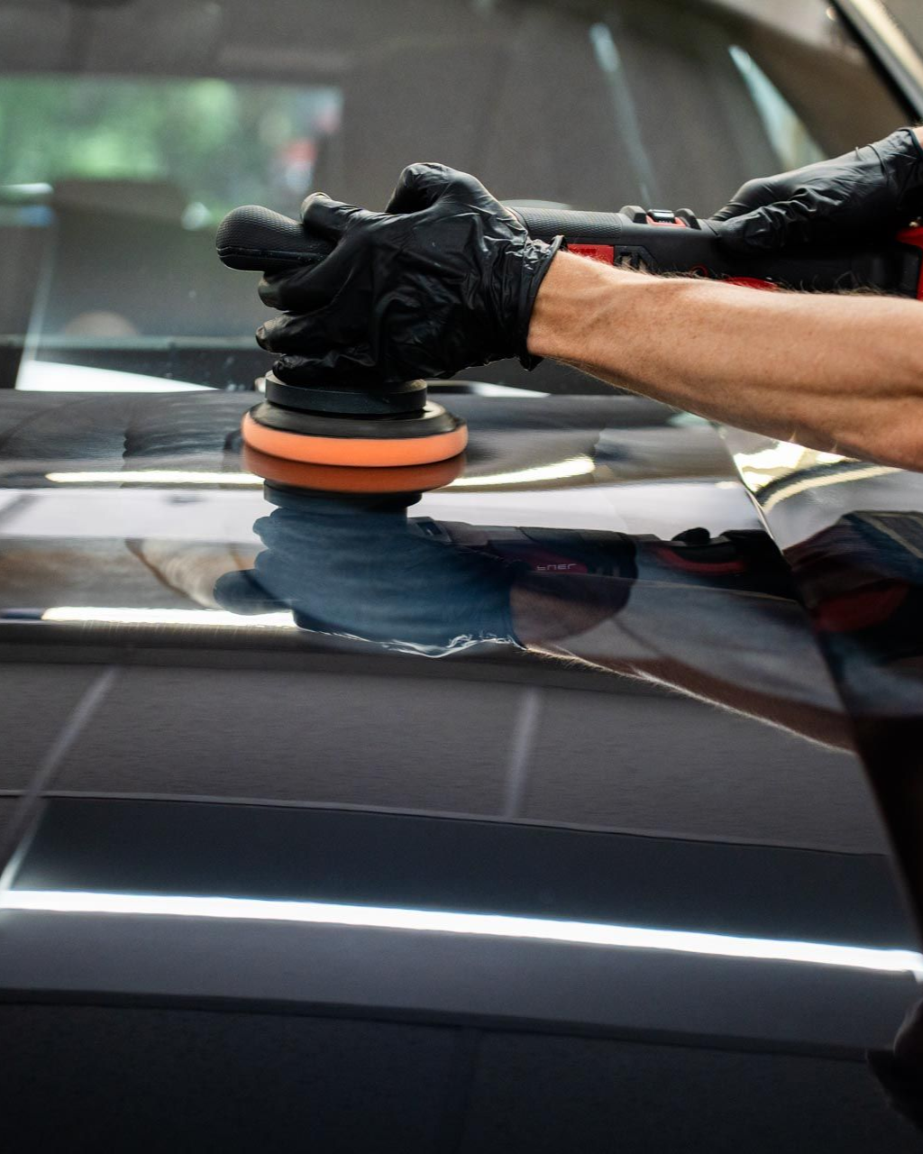 A yellow sports car is parked in a garage.