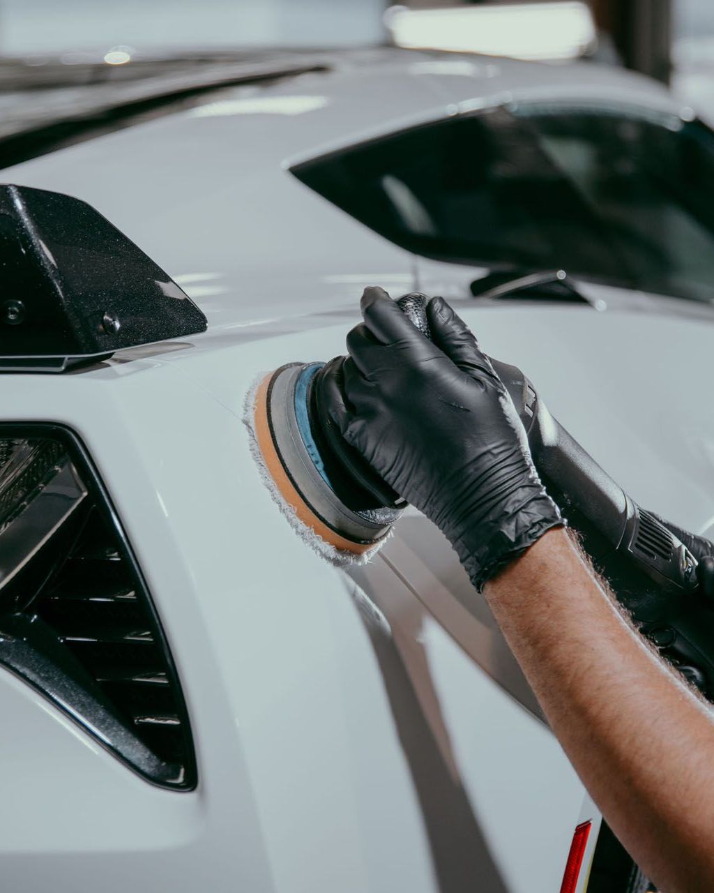 A man is holding a piece of glass with a picture of a cat on it