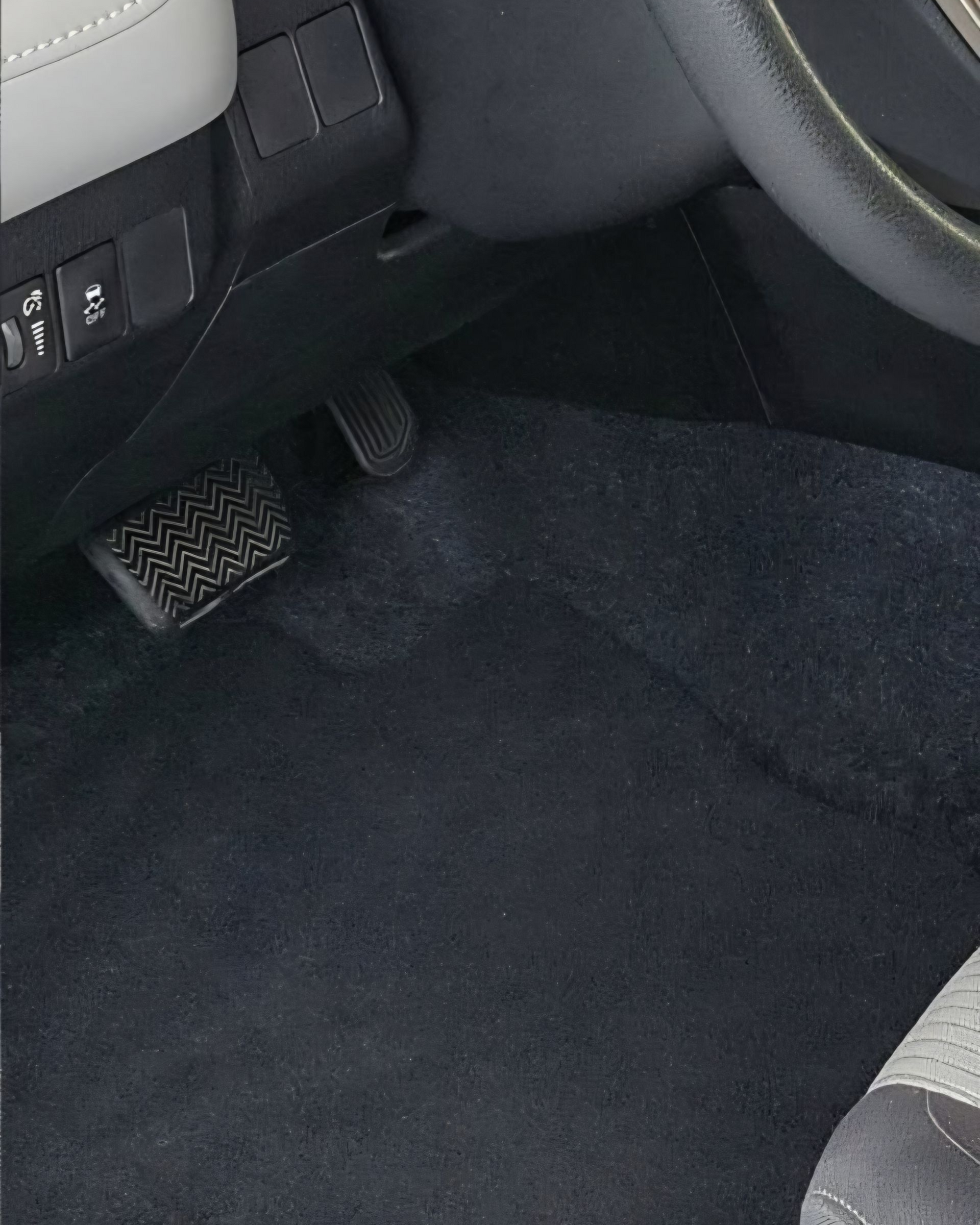 A person wearing black gloves is polishing a black car