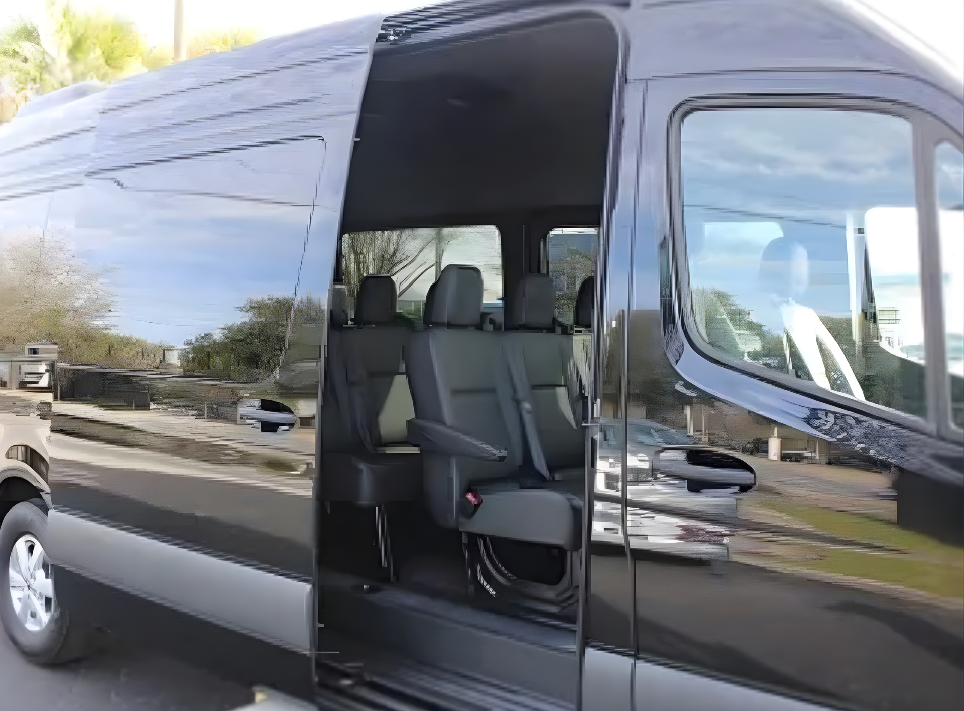 Black passenger van with sliding door open, revealing interior seating.