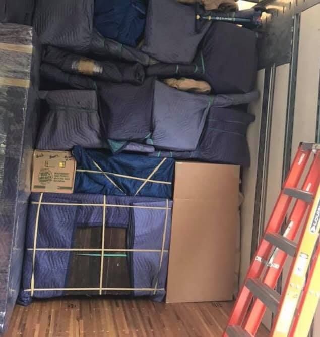 A ladder is in the back of a moving truck