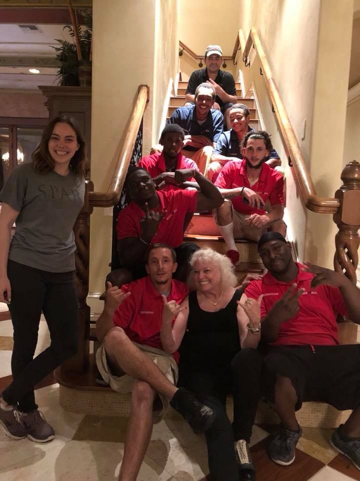 A group of people are posing for a picture on a set of stairs.