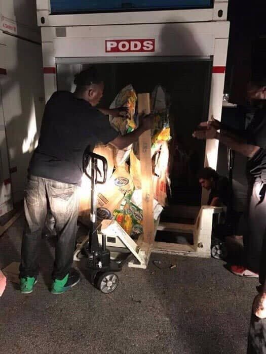 A man is pushing a pallet truck into a pod. 28.4845° N, 81.2519° W