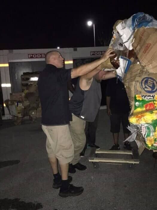 A group of men standing in front of a building that has the word post on it 28.4845° N, 81.2519° W