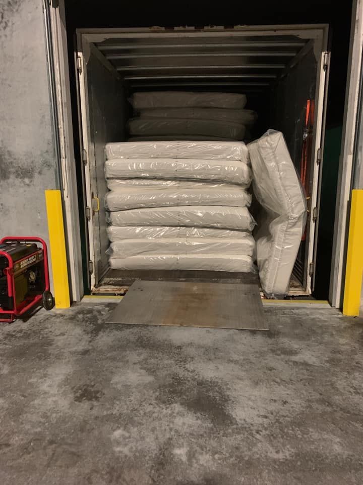 A stack of mattresses is sitting in the back of a truck. 28.4845° N, 81.2519° W