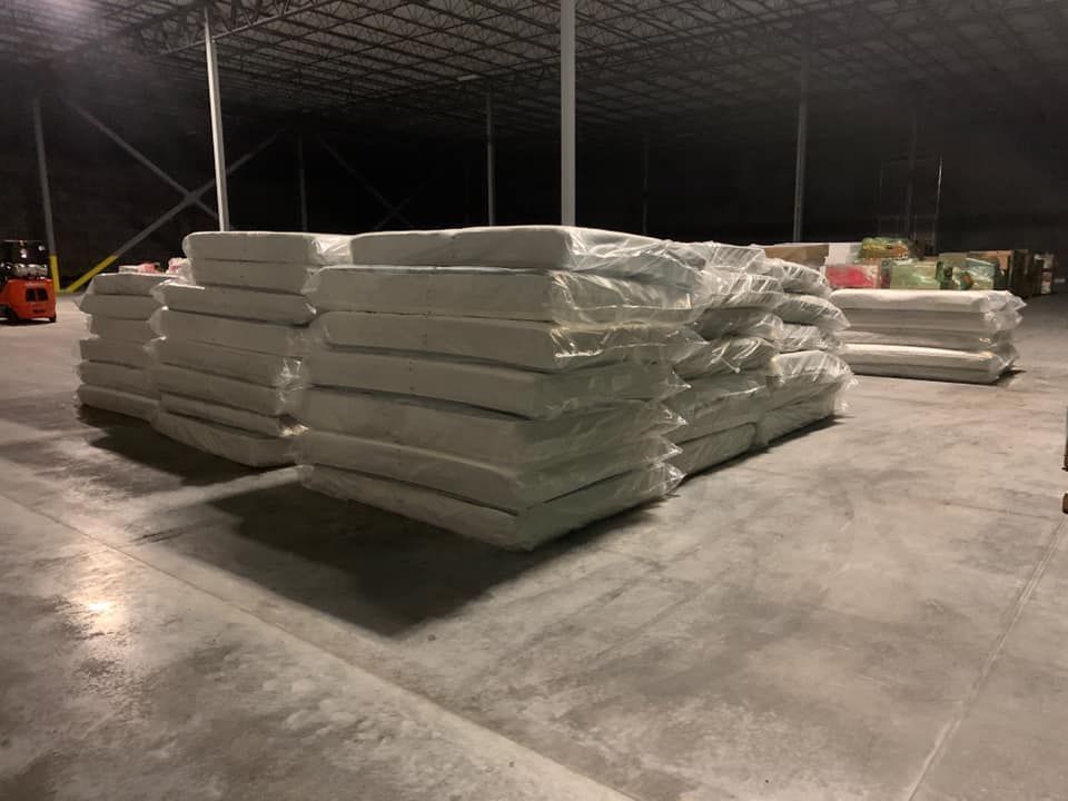 A large warehouse filled with lots of white bags. 28.4845° N, 81.2519° W