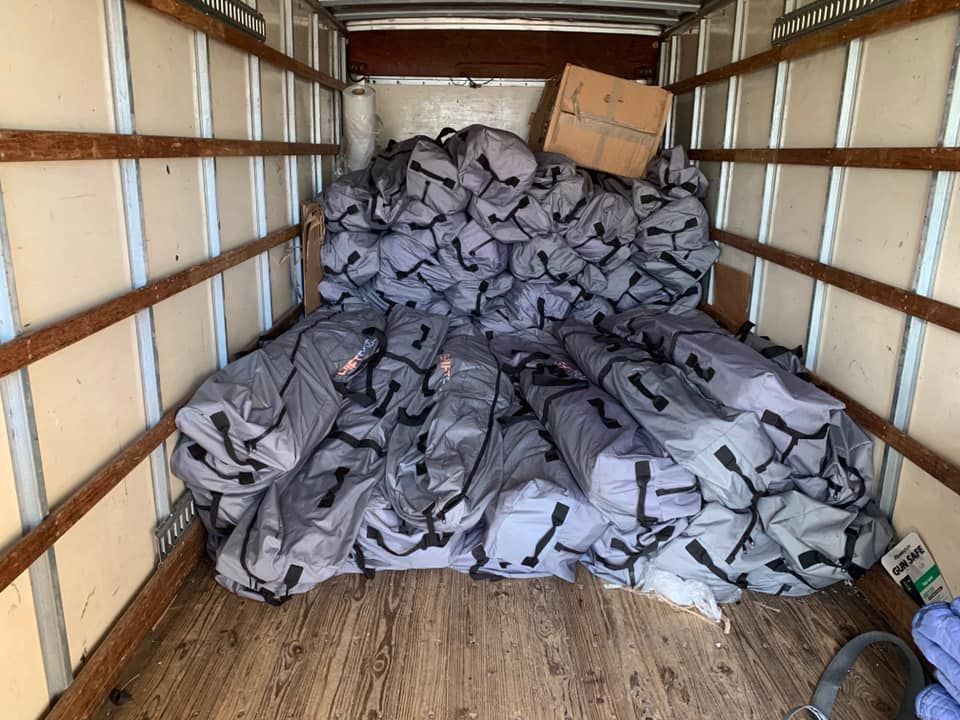 A truck filled with a lot of bags and boxes. 28.4845° N, 81.2519° W