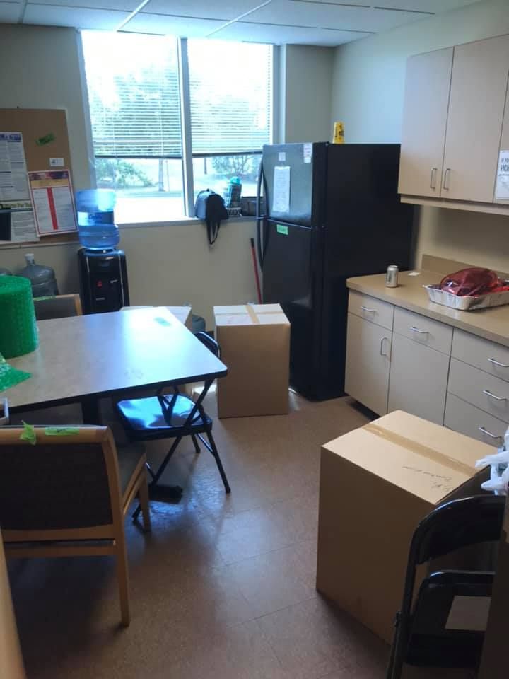 A kitchen with boxes on the floor and a table 28.4845° N, 81.2519° W