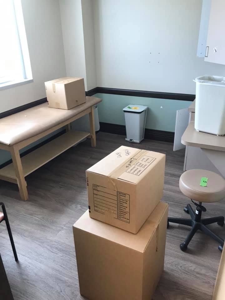 A room with boxes stacked on top of each other and a stool. 28.4845° N, 81.2519° W