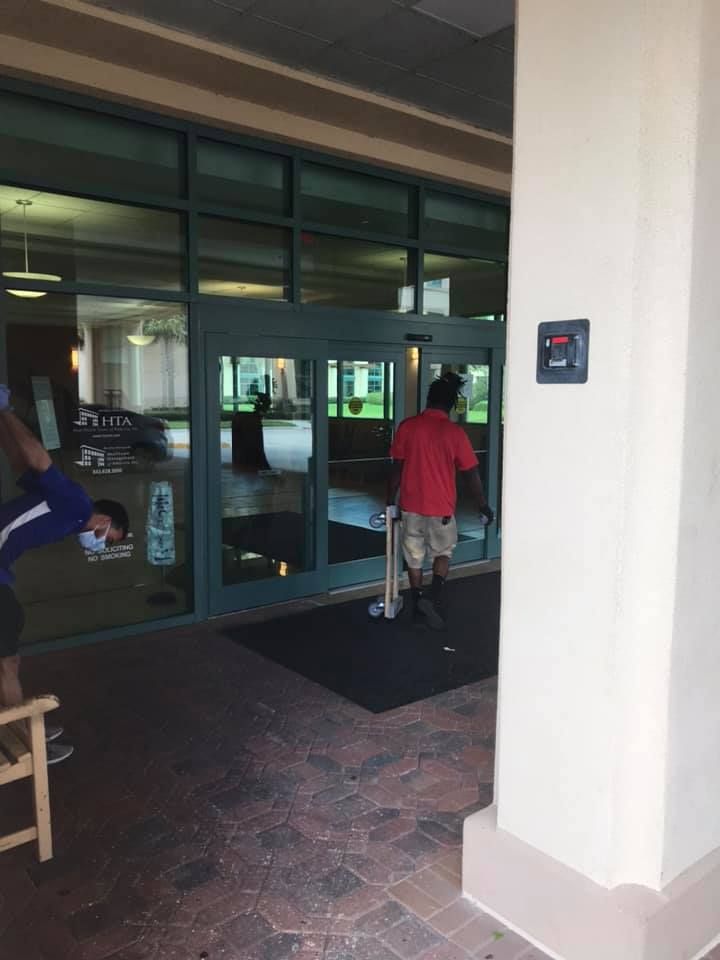 A man is doing a handstand outside of a building 28.4845° N, 81.2519° W