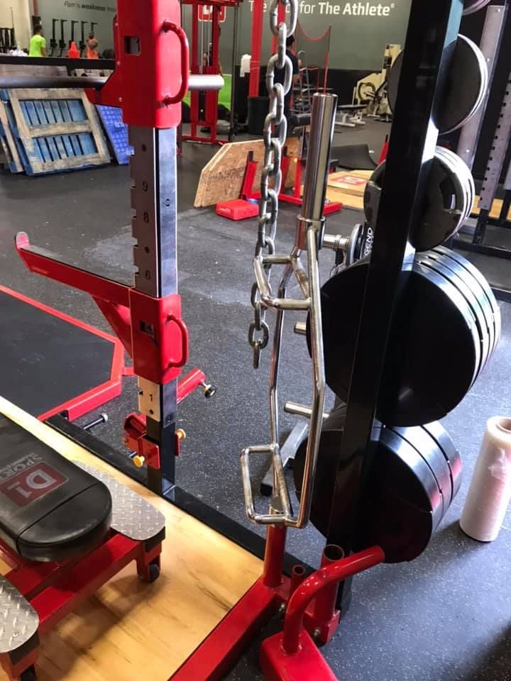 A gym with a chain hanging from a  barbell rack 28.4845° N, 81.2519° W