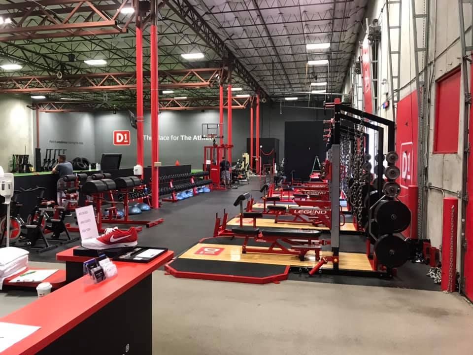 A large gym with a lot of equipment and a reception desk. 28.4845° N, 81.2519° W